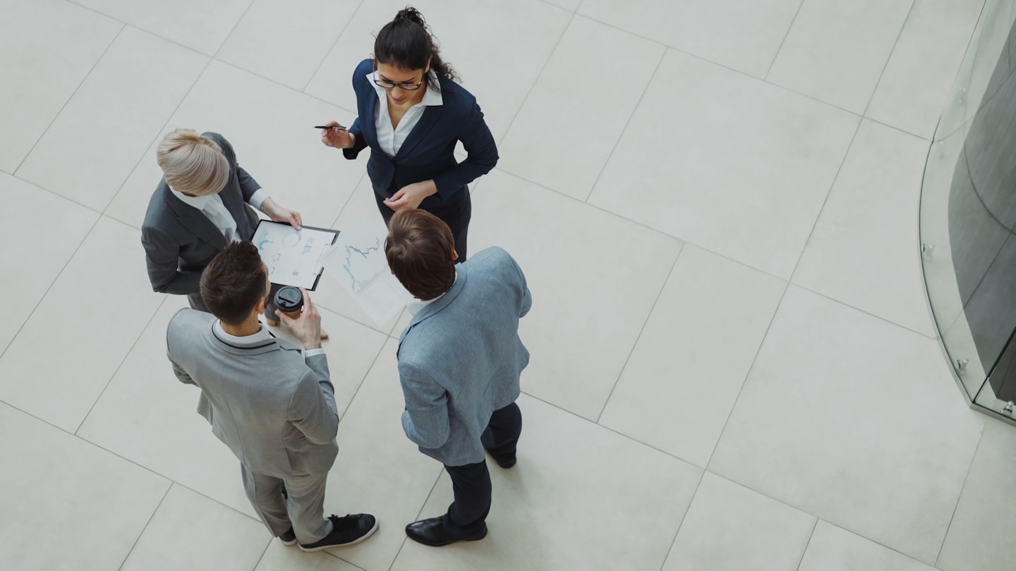 Business professionals collaborating over charts in a modern office.